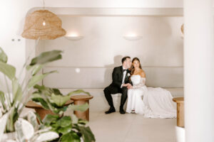 Bride and groom sitting in cocktail lounge