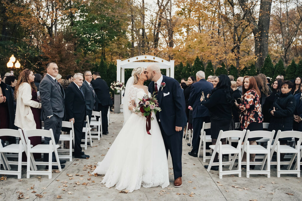 Couple Kissing at Their Outdoor Wedding Ceremony in Boston