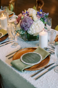 Reception table setting with candles and florals