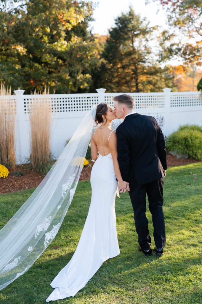 Bride and groom kiss at The Tent gardens