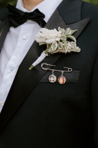 Memorial charms on groom's suit jacket