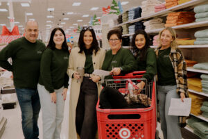 Saphire Event Group Team shops for gifts for families in need during SEG Gives Back holiday giving event.