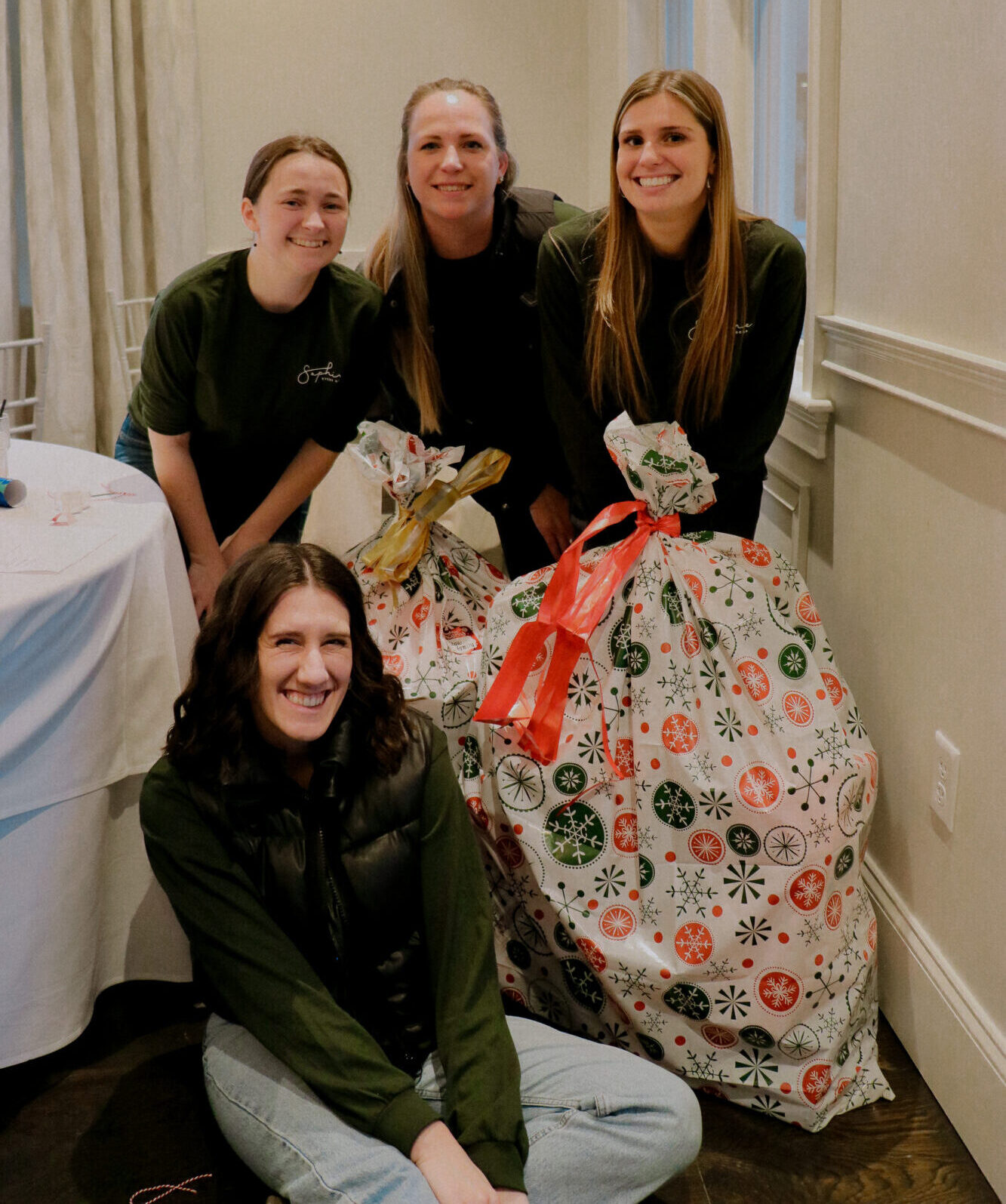 SEG team poses with wrapped gifts for Massachusetts families in need during holiday season.