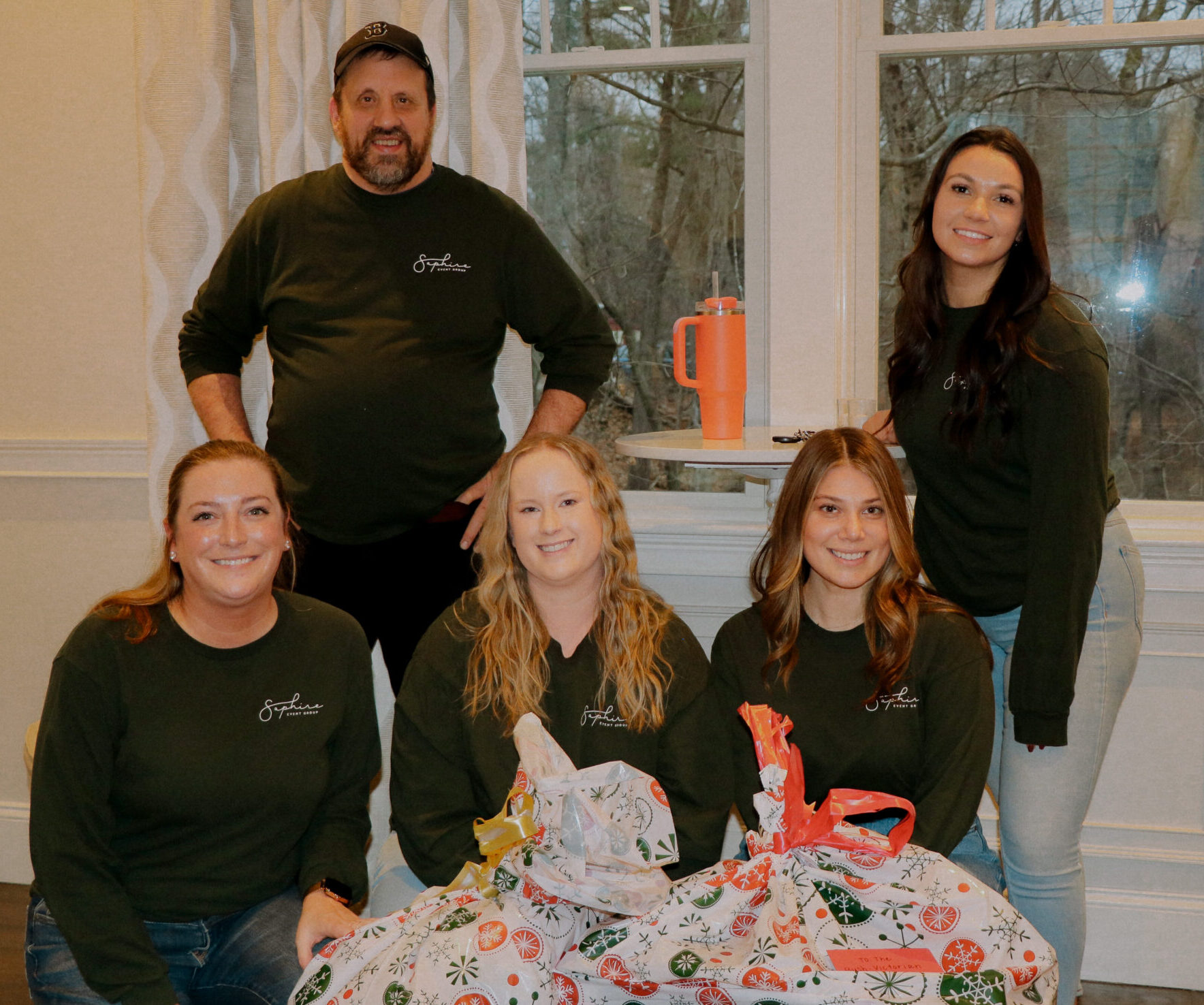 SEG team poses with wrapped gifts for Massachusetts families in need of holiday giving.