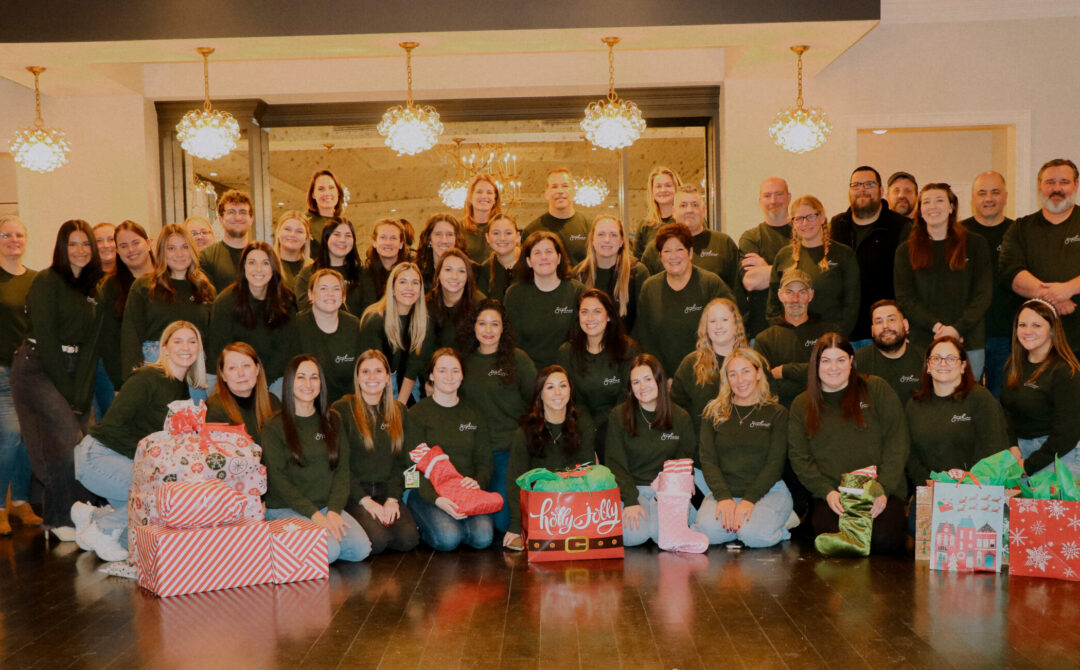 Saphire Event Group team poses with gifts for SEG Gives Back families.