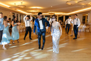 Bride and groom dance on dance floor at wedding reception